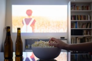 person eating popcorn while binge-watching tv in deer park