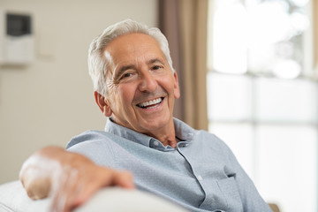 older person with dental implants smiling